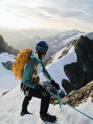 A person climbing up a mountain with a backpack