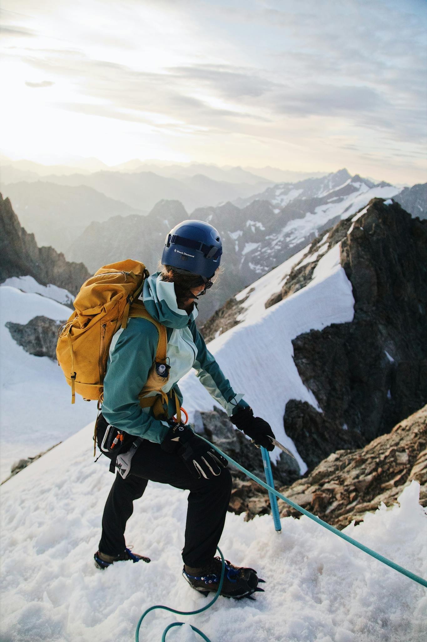 A person climbing up a mountain with a backpack