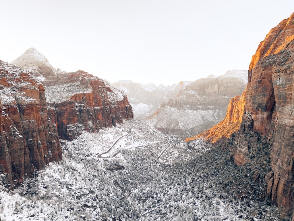 Scenic winter view of snow-dusted cliffs and valleys in Zion National Park.